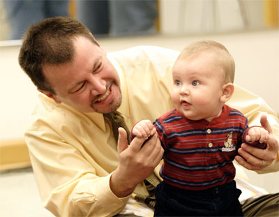 Parent and child enjoying themselves in music class