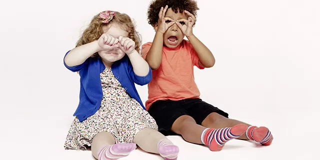 Children singing a song and pretending to be owls
