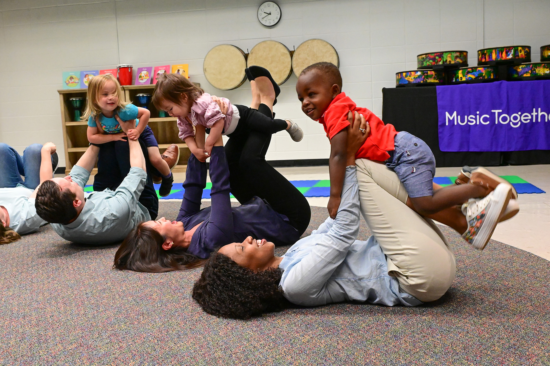 Parents lifting their babies in music class