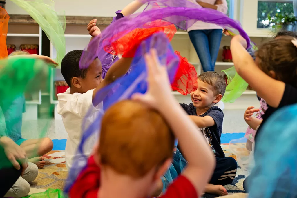 Children playing with scarves in music class