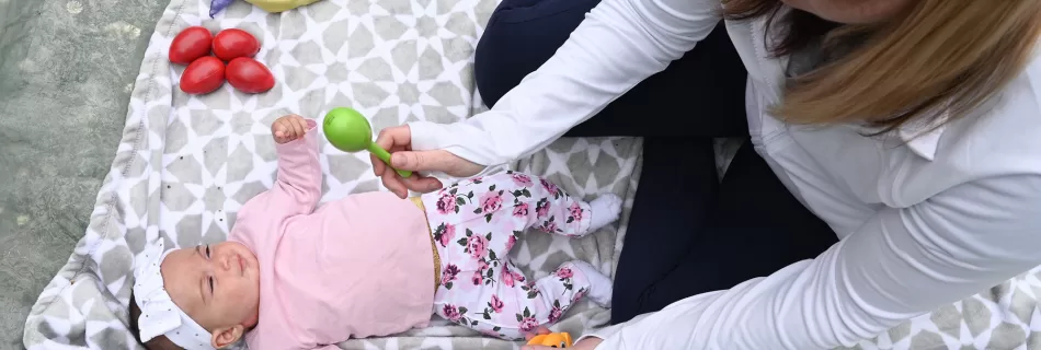 Mom and infant playing maracas