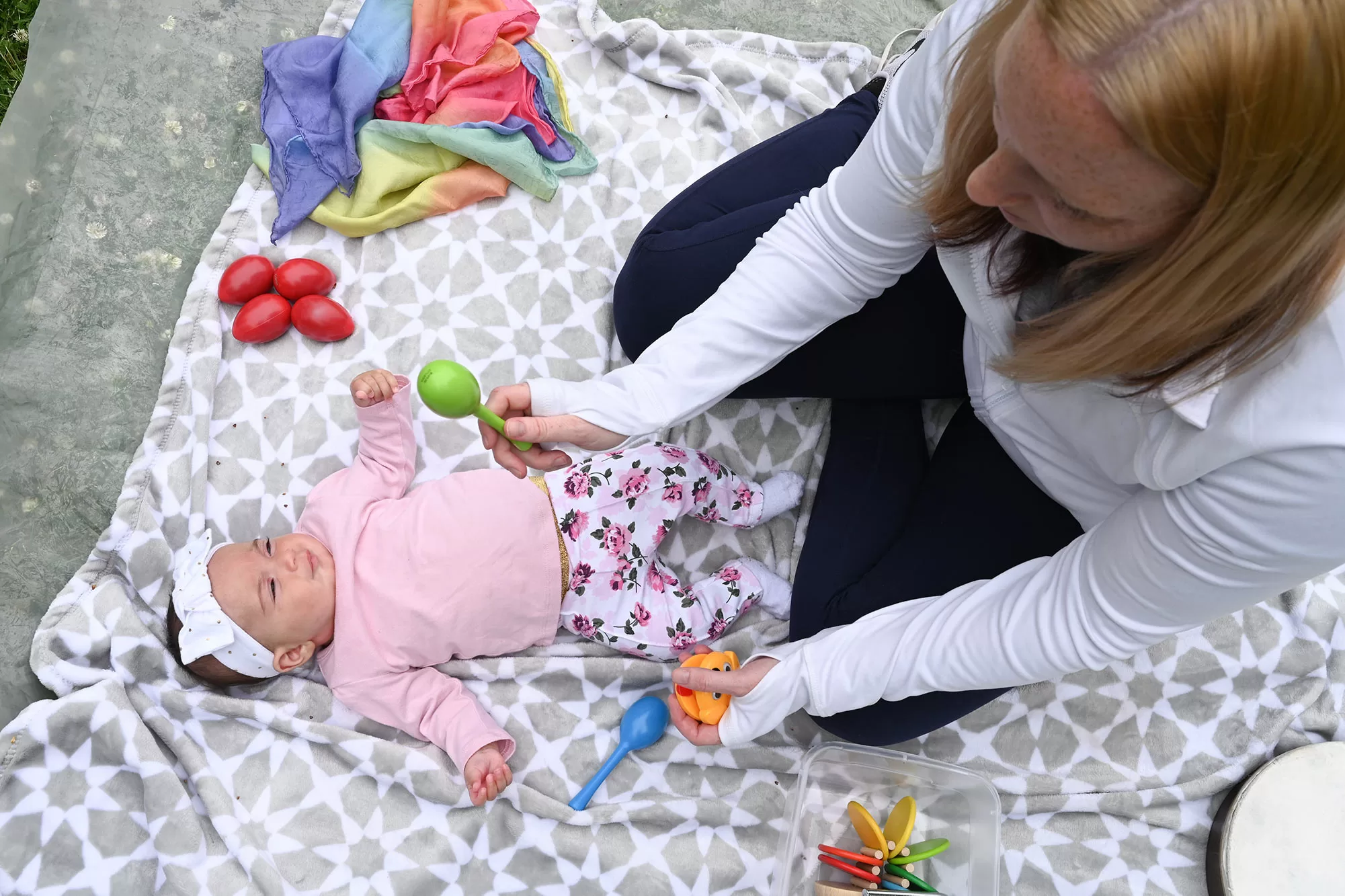 Mom and infant playing maracas