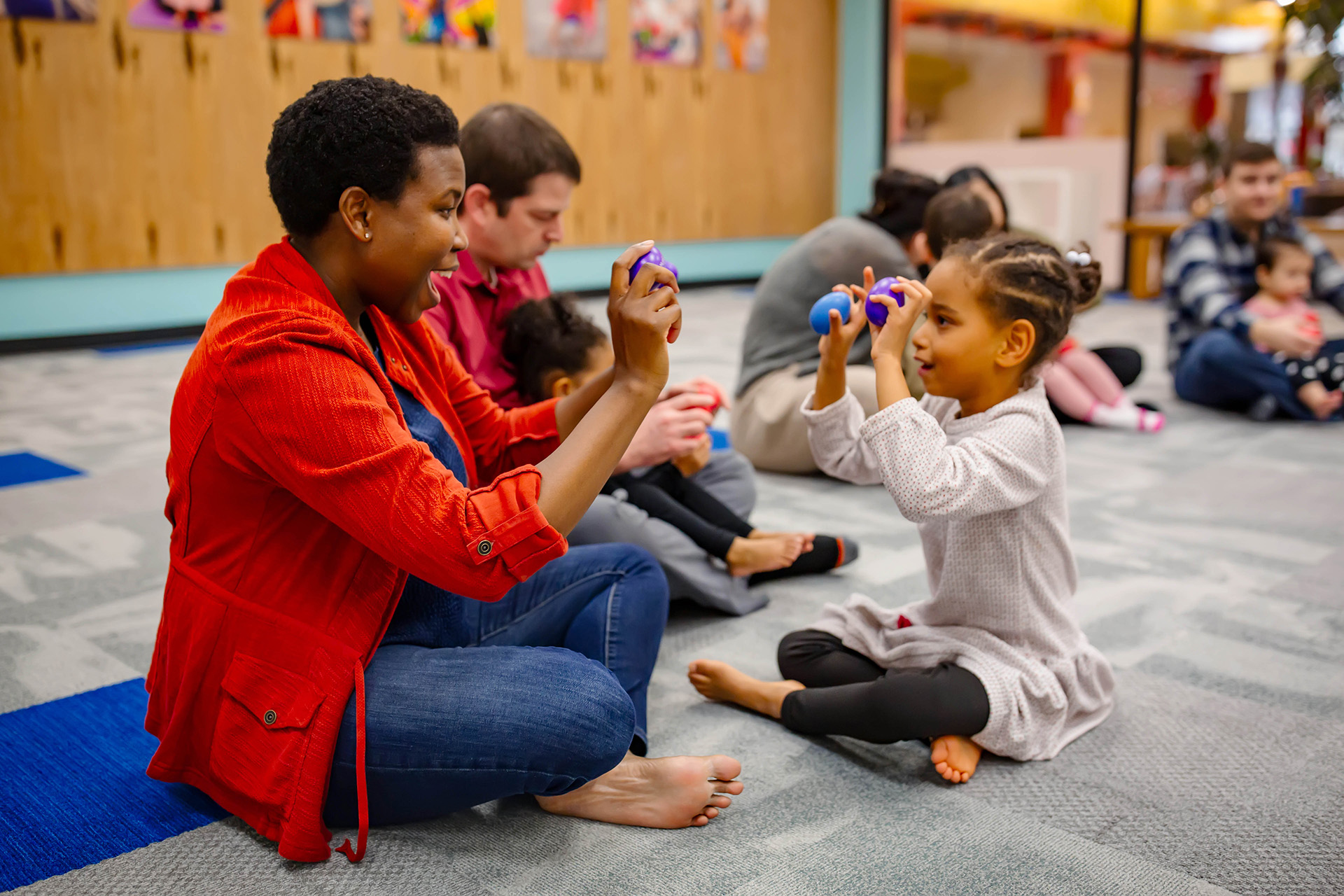 Mom and daughter playing patty-cake in a Music Together class