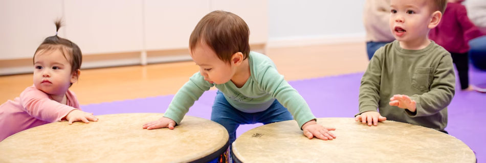 Children playing big drums in Music Together class