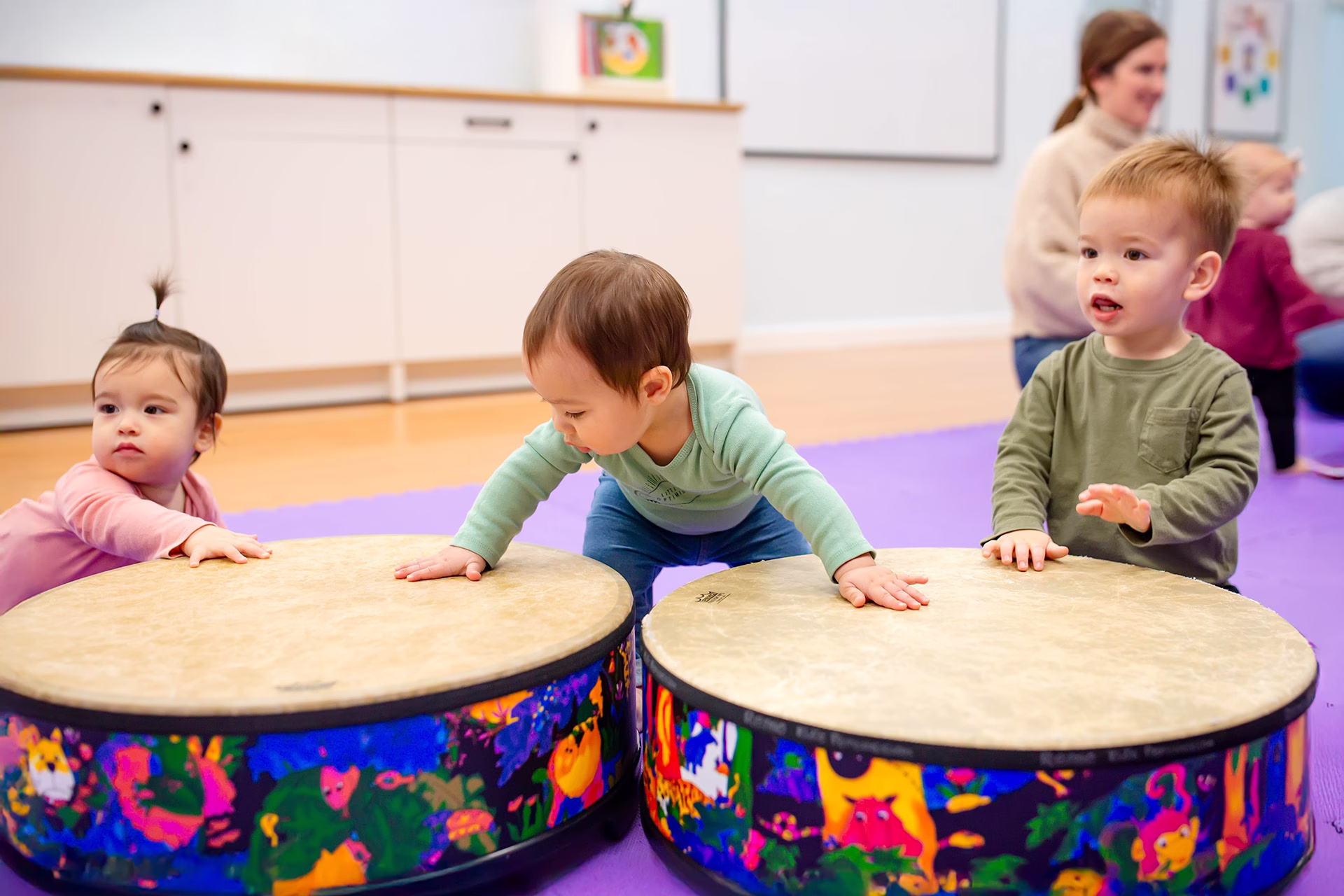 Children playing big drums in Music Together class