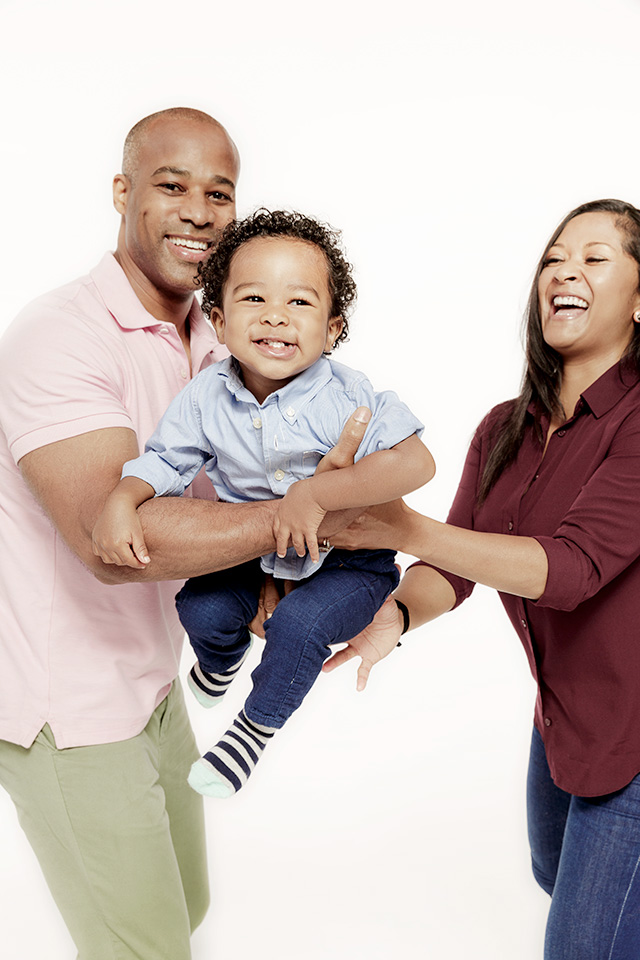Parents swaying a child to the beat